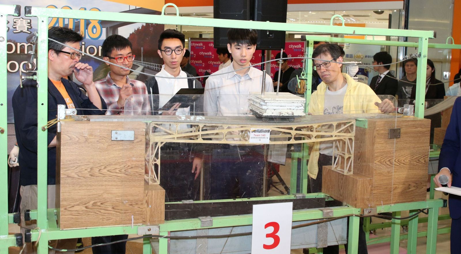 At the final competition today, shortlisted teams each build a bridge model for a test on structural efficiency