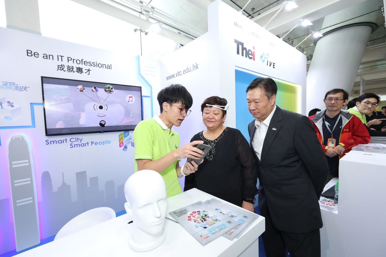 (From second left) VTC Deputy Executive Director Josephine KEA and Acting Deputy Executive Director Edmond YU visit the VTC Booth, showcasing, among others, the “Sleeping Monitor”