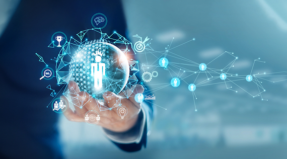 Businessman holding a virtual icon of a human in his hand, with a digital network connection technology and people icons.