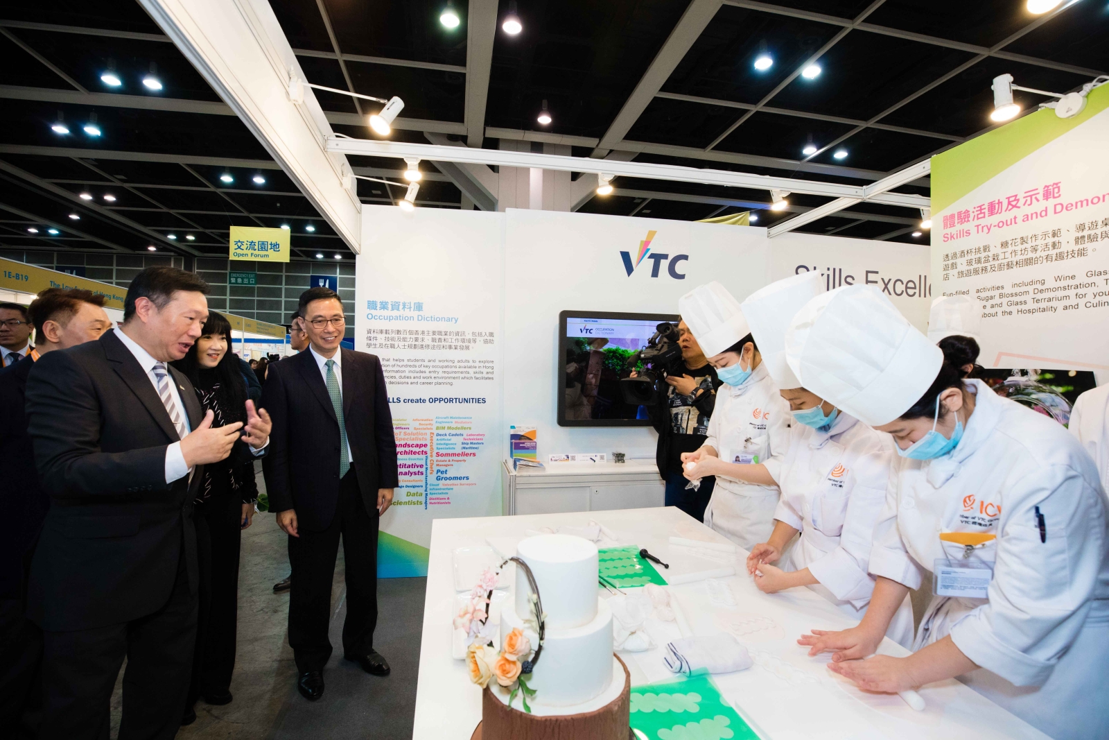Secretary for Education Kevin YEUNG (third from left) tours the VTC Booth, talking to students and teachers to learn about the latest VPET developments